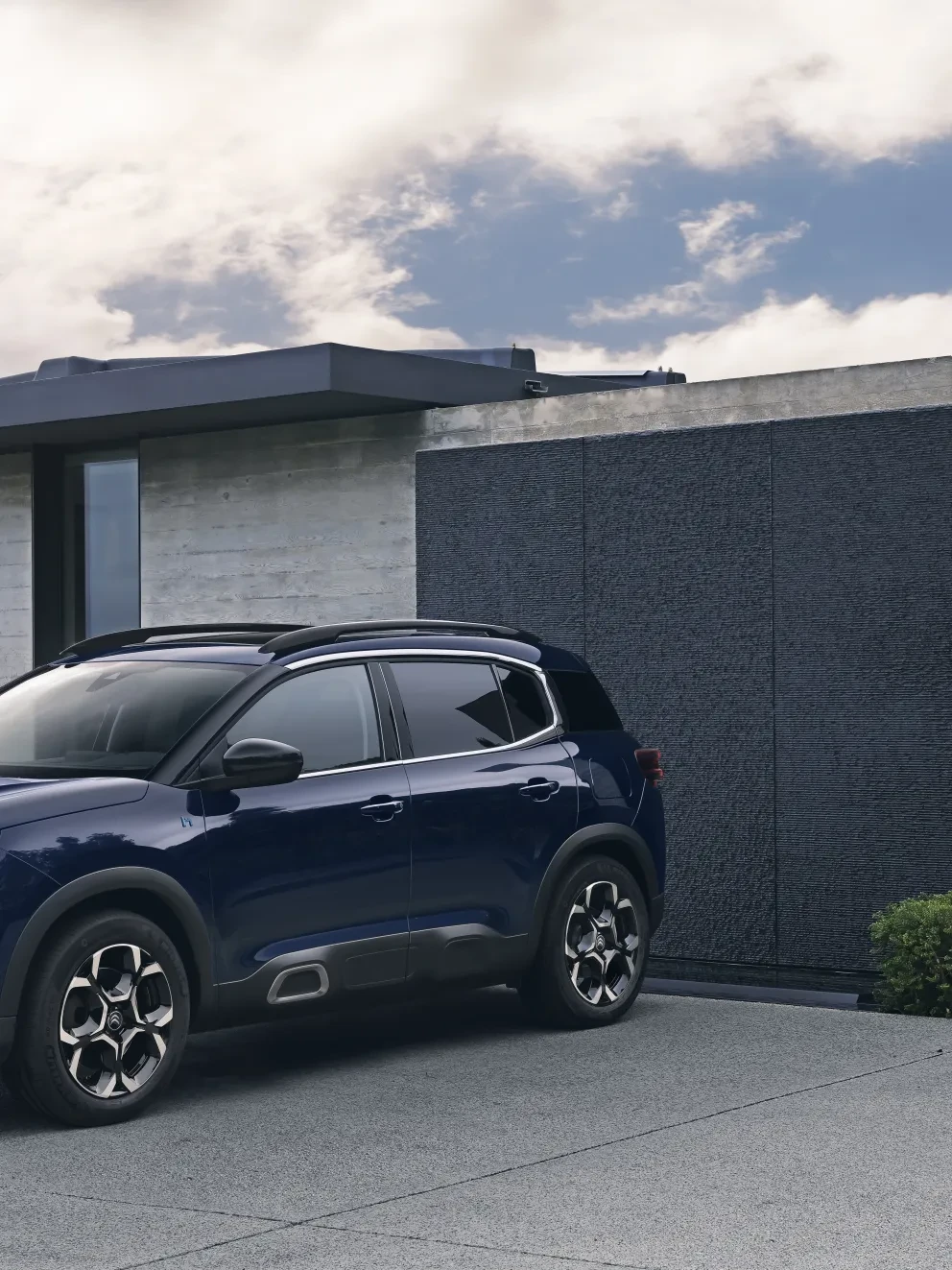 Nieuwe Citroën C5 Aircross in paars op oprit van moderne woning